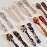 Saltist colourful acrylic spoons and butter knives in assorted tortoiseshell and marble patterns for stylish hosting.