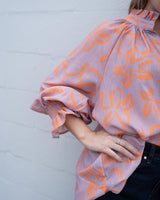 Lavender and orange floral linen-blend top with a high ruffled neckline and smocked puff sleeves, OSFA fit.
