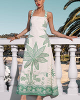 Mia Milani linen-cotton maxi dress in cream with green tropical palm print, featuring adjustable straps and A-line fit.