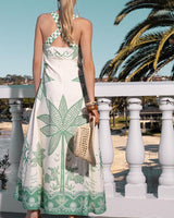 Mia Milani linen-cotton maxi dress in cream with green tropical palm print, featuring adjustable straps and A-line silhouette.