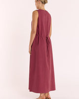 Wine-colored cotton-linen maxi dress with a tank-style cut, round neckline, and a tie-waist detail.