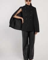 Black wool-blend military cape with a high neckline, double-breasted button front, and structured cape-style sleeves.