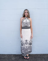 Eloise linen-blend maxi dress with a black and cream botanical print, halter neckline, and form-fitting silhouette.