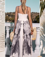 Back view of a white linen-blend sundress with black floral print, adjustable straps, and a shirred back.