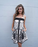 Eloise mini dress in black and white linen-cotton blend with square neckline, adjustable straps, and side pockets.