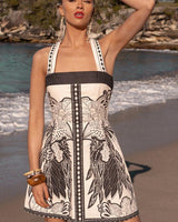 Eloise mini dress in cream and black linen-cotton blend with a square neckline, adjustable straps, and floral print.