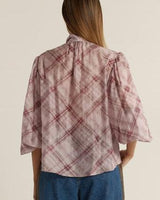 Back view of an orchid pussybow blouse with a relaxed fit, plaid pattern, and elasticated sleeves.