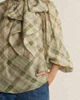 Eve pussybow blouse in a beige and green plaid print with voluminous sleeves and a statement neck tie.