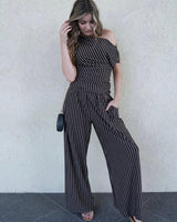 Woman wearing a one-shoulder metallic stripe jersey top with ruched detailing and matching wide-leg trousers.
