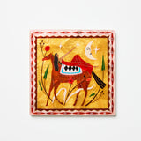 Decorative wall art with a horse and geometric patterns on a yellow background