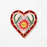 Decorative heart-shaped plate with a sun design on a white background