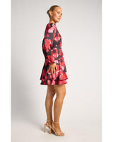Faith floral mini dress featuring a bold red and black print, wrap-style waist, long sleeves, and a layered ruffle hem.