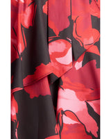 Close-up of a Faith floral mini dress featuring a bold red, pink, and black abstract floral print with layered ruffles.