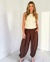 Model wearing chocolate brown balloon-fit Frankie pants with a relaxed, flowing silhouette and drawstring waist.