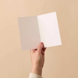 Christmas Greeting Card held open showing blank white interior on FSC-certified card stock with clean, smooth finish