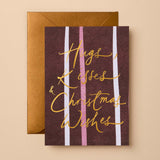 Christmas Greeting Card with red, pink, and white vertical stripes and gold foil "Hugs, Kisses & Christmas Wishes" lettering with gold envelope.
