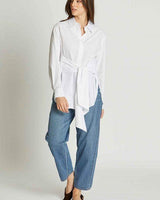 Classic white 100% cotton wrap-style shirt with an adjustable front tie, worn with blue jeans.
