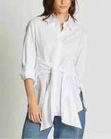 Classic white 100% cotton wrap-style shirt with a front tie detail and long sleeves worn with blue jeans.
