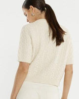 Cream cable knit short-sleeve cardigan with a ribbed hem and soft textured finish.