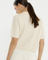Cream cable knit short-sleeve cardigan with a ribbed hem and soft textured finish.