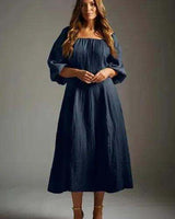 Navy blue cotton linen midi dress with a square neckline and voluminous puff sleeves.