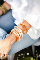 Greenwood Designs handmade resin stacking cuffs in assorted colors stacked for a vibrant layered look