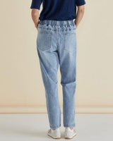 Back view of light blue Haven straight leg jeans with an elasticated waist, drop-crotch, and functional back pockets.