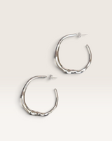 House of Holabox platinum heartline hoop earrings with an organic sculptural silhouette and polished finish.
