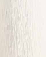 Close-up of white textured jersey fabric with vertical crinkled detail for Heidi high-waisted pants.