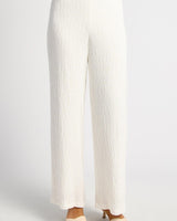White high-waisted straight-cut pants in textured jersey fabric with a flattering drape.