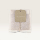 House of Holabox Addition Studio bath brew tea bag with a minimalist paper tag on a neutral background
