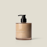 House of Holabox Addition Studio hand moisturiser in a 390ml glass bottle with a black pump dispenser
