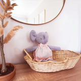House of Holabox Alimrose Baby Elsie Elephant soft toy in a striped dress sitting in a wicker basket