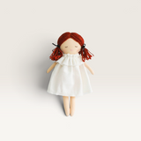 House of Holabox Alimrose Mini Matilda soft doll with red yarn hair and a white dress showing her asleep expression.