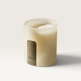 House of Holabox al.ive body soy candle in a sculptural frosted glass vessel with a minimalist label on a marble surface