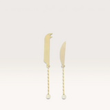 House of Holabox Amalia set of two stainless steel cheese knives with decorative twisted handles and resin accents.