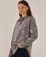 House of Holabox Athena Shirt: brown and white pinstripe cotton with blue eye-heart print, collared, button-front.
