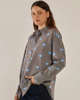 House of Holabox Athena Shirt: brown and white pinstripe cotton with blue eye-heart print, collared, button-front.