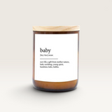 House of Holabox soy candle in an amber glass jar with a wooden lid, featuring a baby dictionary definition label.