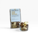 House of Holabox Proper Treats Co. Basque cheesecake bites in a clear pouch and a small glass bowl.