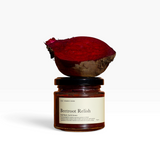 House of Holabox Beetroot Relish in a glass jar topped with a fresh halved beetroot on a warm terracotta background.