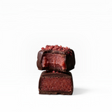 House of Holabox vegan dark chocolate truffle with a pink berry ganache center and raspberry topping