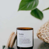 House of Holabox Bestie soy and coconut wax candle in an amber glass jar with a wooden lid and dictionary definition