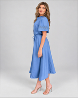 House of Holabox blue midi dress with tie waist, short sleeves featuring cutwork detail, and scalloped hem on a model