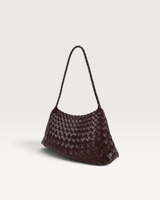 House of Holabox brown woven PU shoulder bag with a braided handle and textured finish against a neutral background.