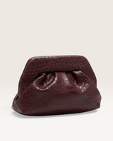 House of Holabox Maya clutch in burgundy with a soft gathered construction and an embossed woven-effect texture.