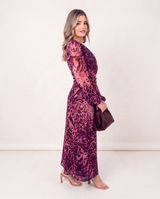 House of Holabox Carmel maxi dress in cerise safari animal print with long sleeves, worn by a blonde model.