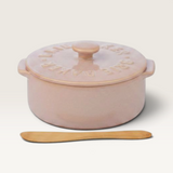 House of Holabox Loire ceramic brie baker in soft pink with a matching lid and a wooden spreader knife.