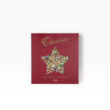 House of Holabox Chocolatier milk chocolate star speckle in a festive red box with a star-shaped window.