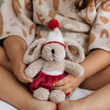 House of Holabox mini Christmas Theodora rabbit soft toy with caramel fur, red velvet skirt, and matching hat.